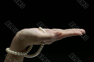 Female hand with pearls Female hand with pearls