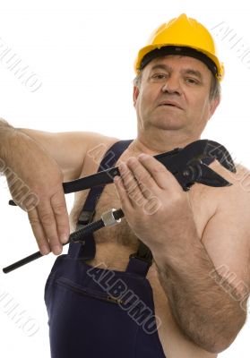 Plumber with pipe wrench and safety helmet