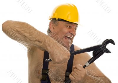 Plumber with pipe wrench and safety helmet