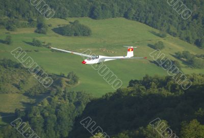 A glider Janus flying over Challes les eaux