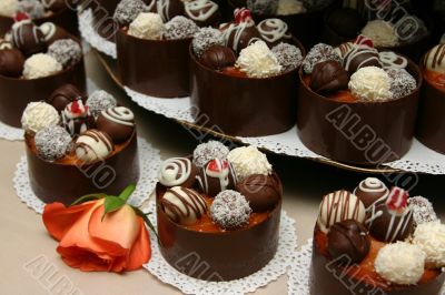 Tower of decorated wedding desserts.