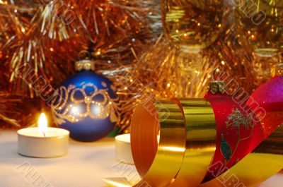 The burning candles, balls and gold ribbons it are Christmas