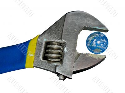 Concept planet earth globe in old adjustable spanner wrench isolated over white