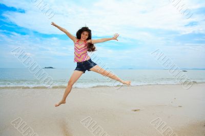 happy fun jump at the beach