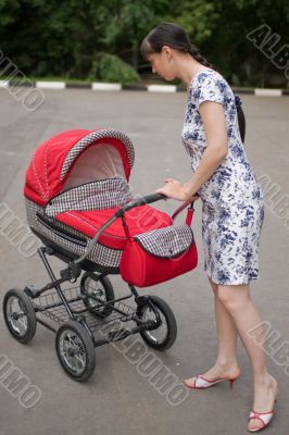 Woman with baby carriage Woman with baby carriage