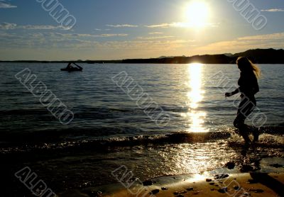 Silhouette woman jumping at the beach