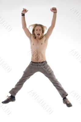 shirtless man jumping high in joy