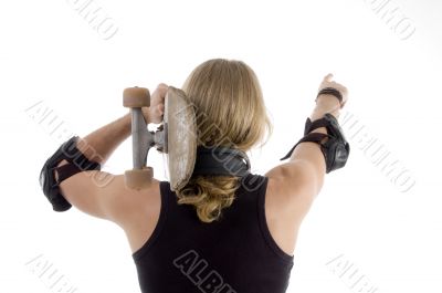 caucasian skateboarder pointing backwards