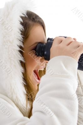 happy female using binocular to watch