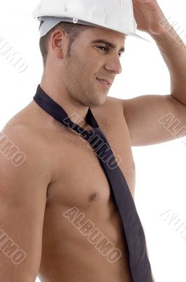 side view of muscular man wearing architect helmet side view of muscular man wearing architect helmet