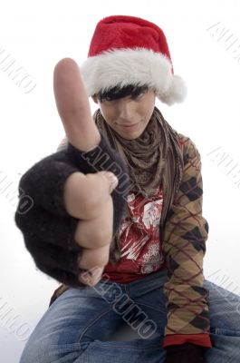 young boy wearing christmas hat showing thumb young boy wearing christmas hat showing thumb