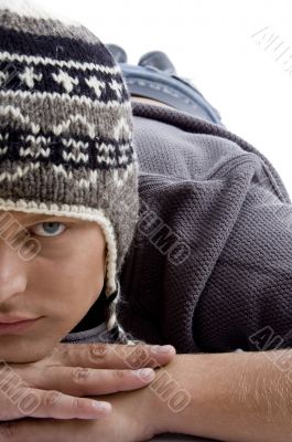 close view of laying young male wearing winter cap close view of laying young male wearing winter cap