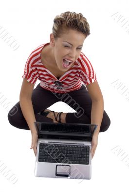 winking beautiful model with laptop