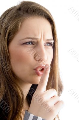 female showing keep shushing sign in anger