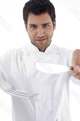 portrait of male chef holding cutlery