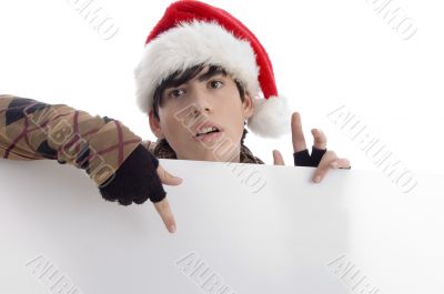 young boy wearing christmas hat indicating placard