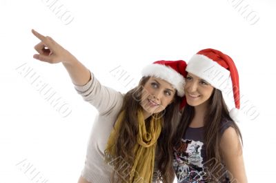 females in christmas hat pointing sideways