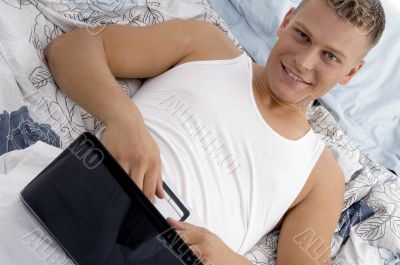 male putting laptop on his stomach