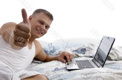 man with laptop and thumbs up
