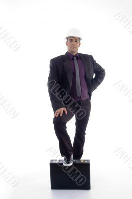 full  pose of architect with one leg on briefcase