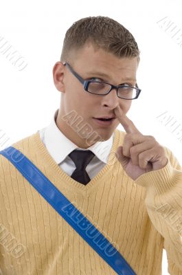 teenaged student digging his nose