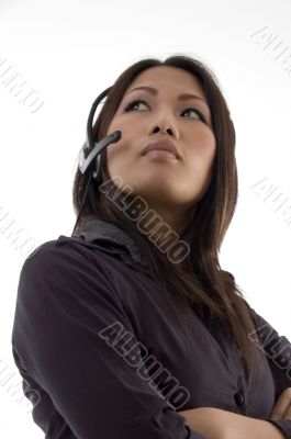 female with earphone and looking upward