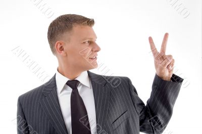 portrait of businessman showing peace sign portrait of businessman showing peace sign