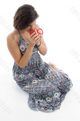 high angle view of young woman drinking coffee high angle view of young woman drinking coffee