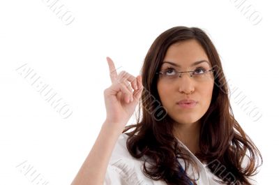 pretty female wearing eyeglasses pointing upwards pretty female wearing eyeglasses pointing upwards