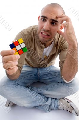 confused male holding puzzle cube