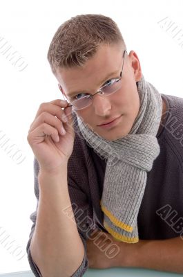 young male holding eyewear