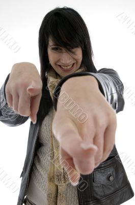 cheerful woman pointing towards camera