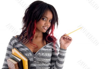 school girl posing with pencil and books