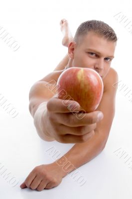 laying fit guy showing apple