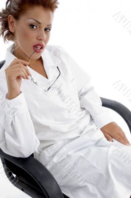 sitting female doctor holding eyewear