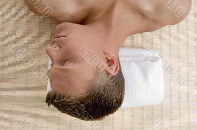 male lying on mat ready to take spa treatment