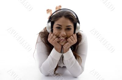 young female lying and enjoying music