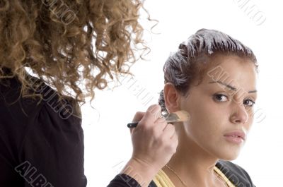 beautician doing make up of woman