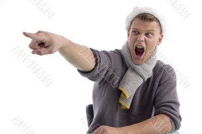 shouting male with christmas hat pointing aside