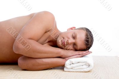 male lying on mat ready to take spa treatment