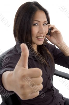 woman showing thumbs up while talking