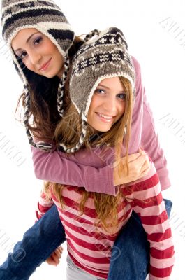 young girl giving piggyback to her friend