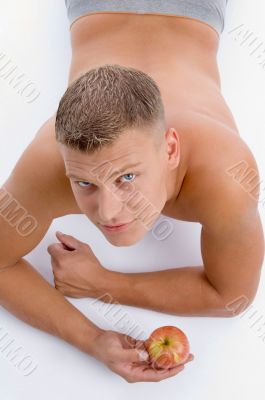 high angle view of muscular man with apple