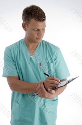 young male writing on writing pad