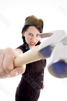 beautiful young woman striking with hammer