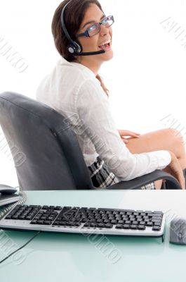 side view of smiling woman sitting in office