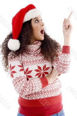 young female with christmas hat indicating upward