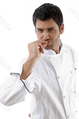 young chef posing with hands on mouth