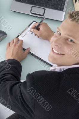 smiling ceo with pen and writing board