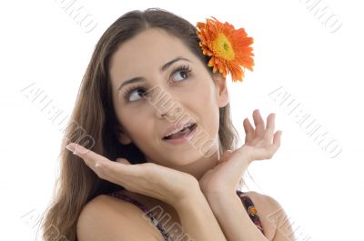 female with gerbera in hair giving expression